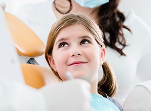 Young girl smiling at dentist