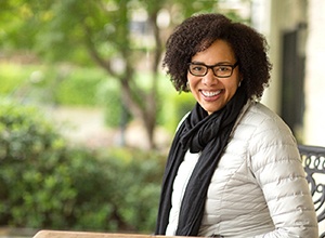 Smiling woman sitting on bench outside