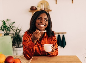 Woman enjoying a cup of yogurt