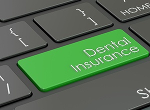 Dental insurance key on computer keyboard