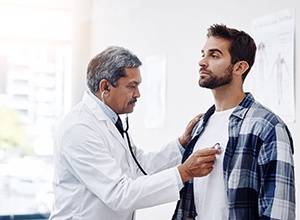 Man undergoing physical at his doctor’s office