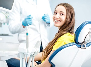 Happy dental patient looking over her shoulder