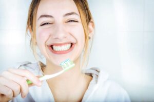 Happy woman holding her toothbrush